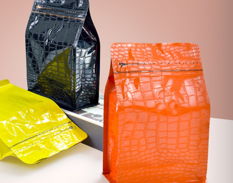 Custom printed orange and black bags with tactile finishes